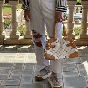 L’AGENCE ripped, natural frayed, tie-dyed, cropped jeans.